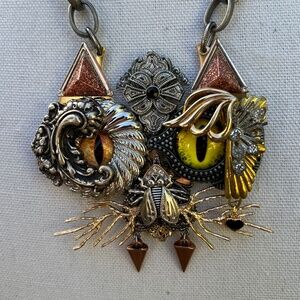 Black cat mom and jewelry collage artist participating in the circular economy.